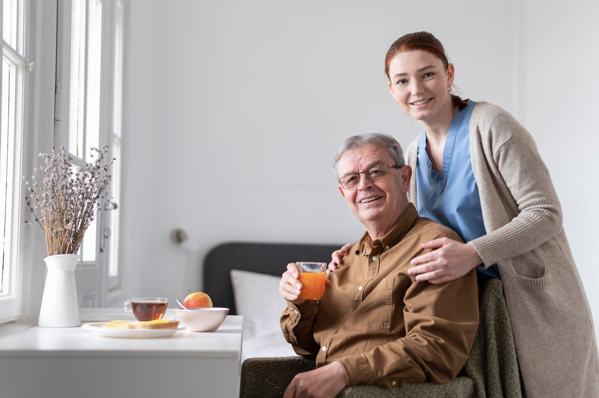 Caregiver and senior with laptop