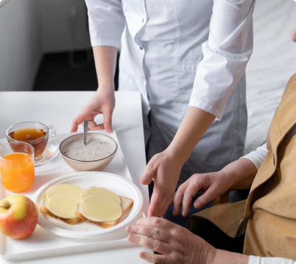 Senior receiving compassionate feeding assistance