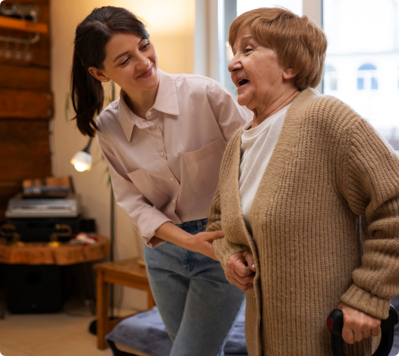 Caregiver providing transfer support to elderly client
